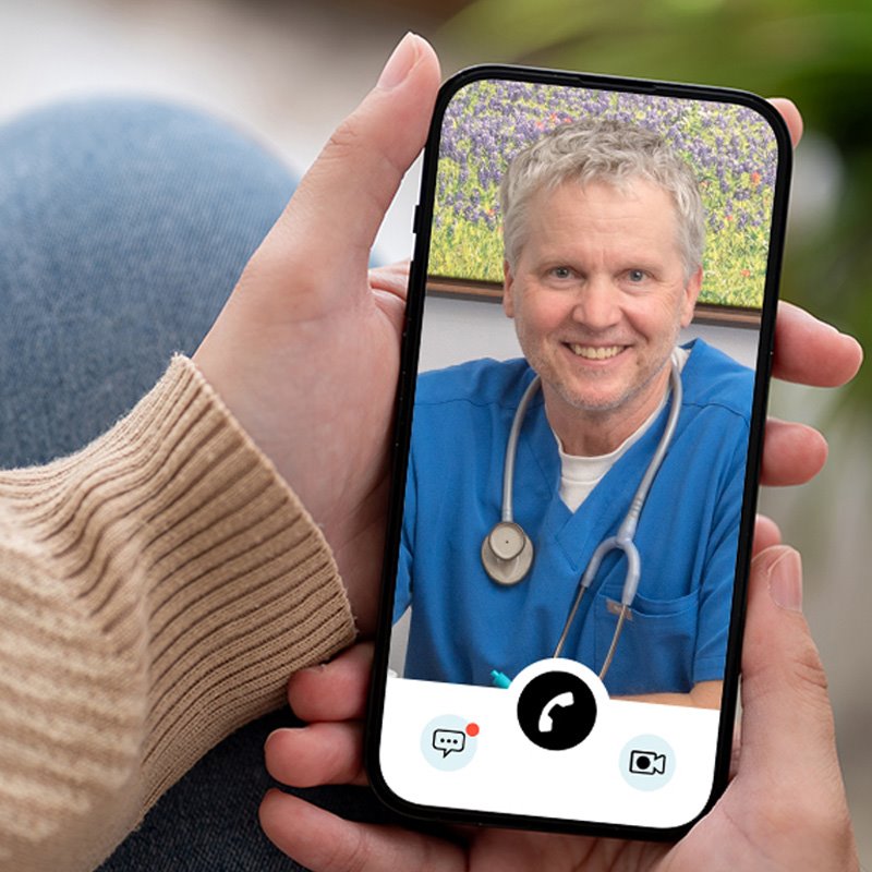Patient using their cellular device to complete their virtual visit with a NormanMD physician