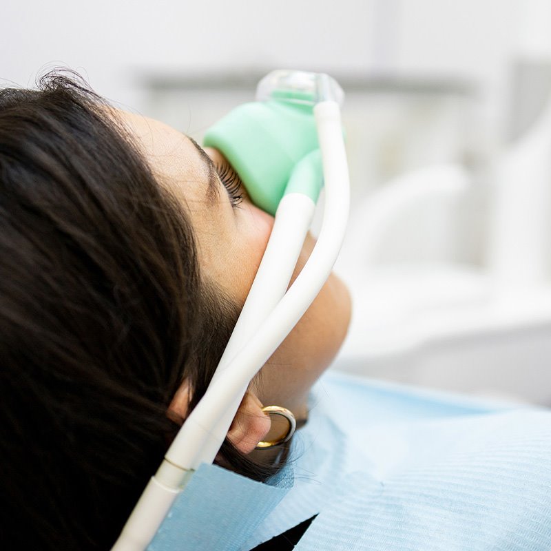 Woman receiving nitrous oxide by mask during a gynecologic procedure