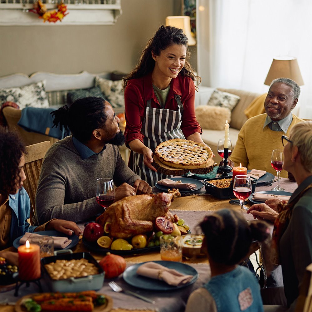 Family enjoying Thanksgiving dinner, representing good health and confidence in their health care providers