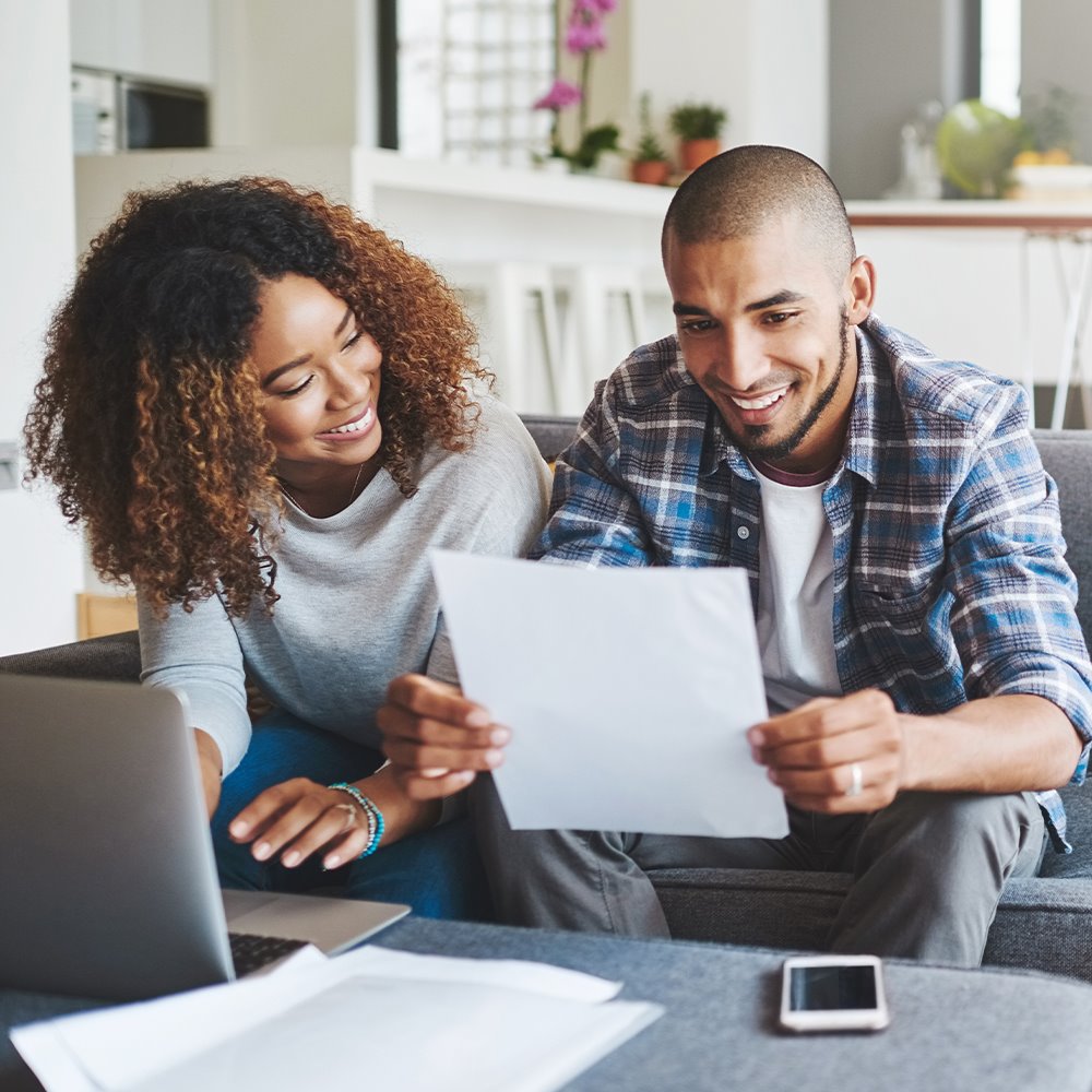 Young couple reviewing their insurance plan options from the Health Insurance Marketplace during annual enrollment