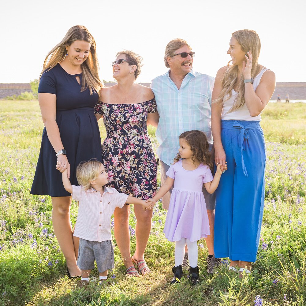 Happy family outside, representing good health and protection after receiving vaccinations